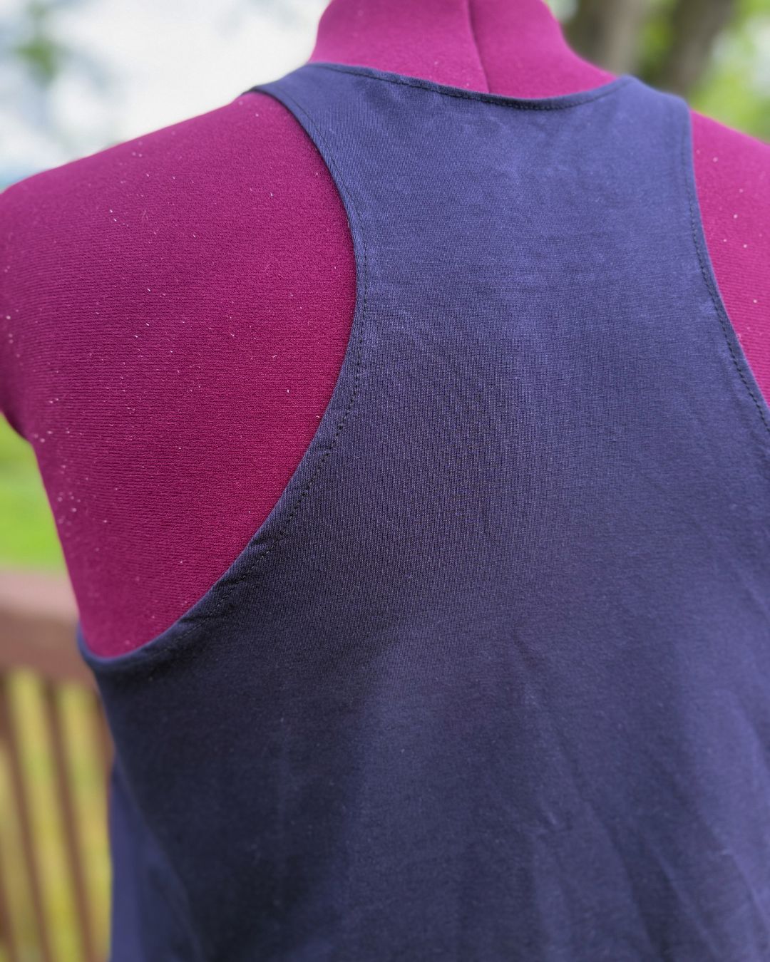Plus size navy blue racerback tank top view of the racerback. 