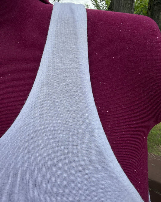 Plus size white casual racerback tank top close up view of the front shoulder. 